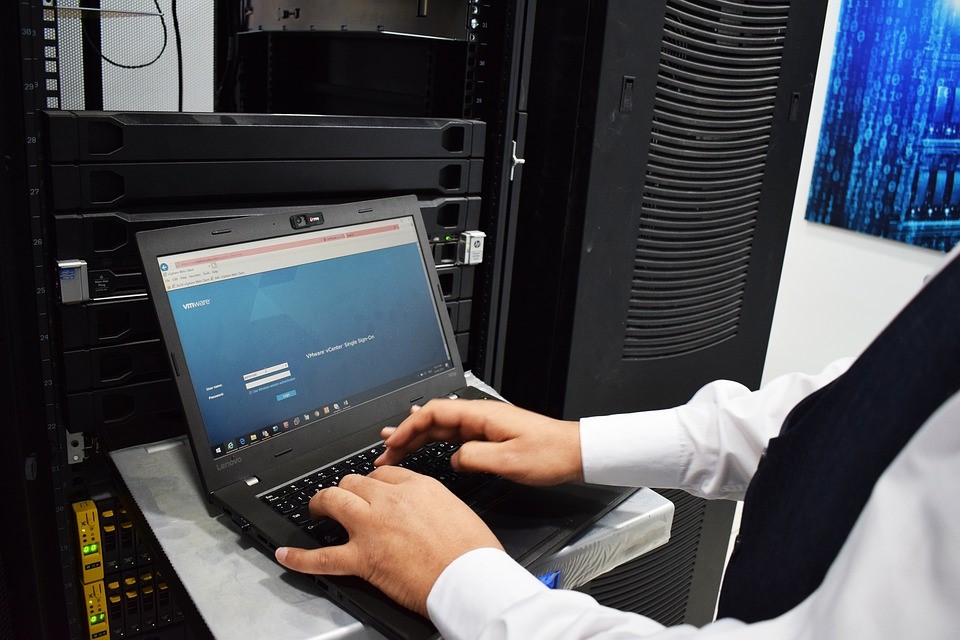 Worker using laptop in a data center