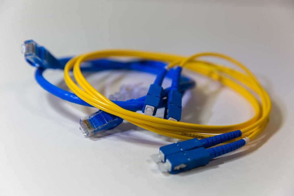 Two blue and yellow fiber optic cables