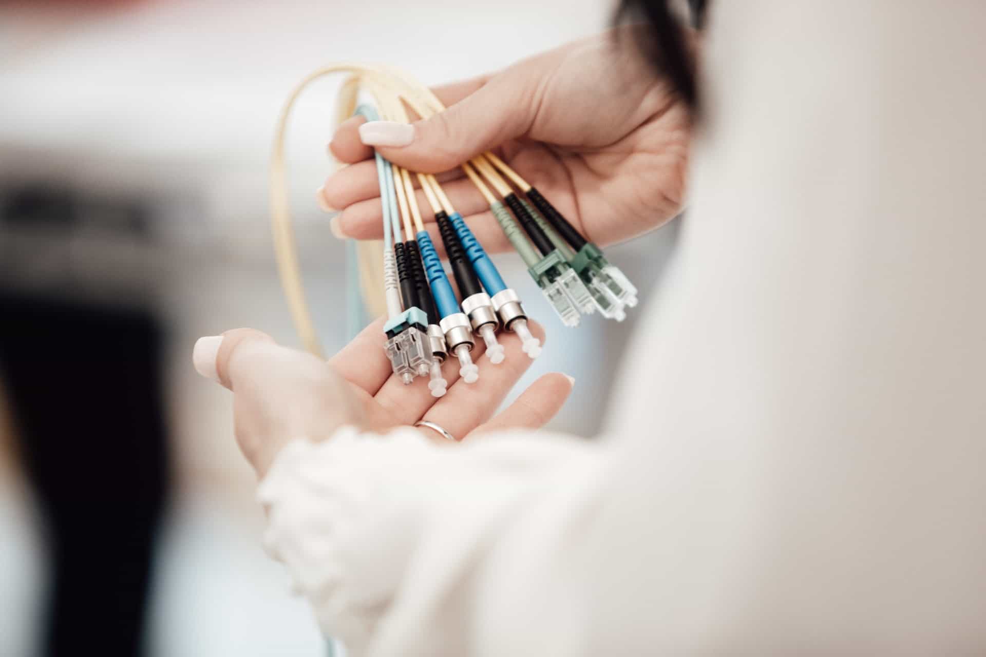 Woman holding the ends of several thin fiber optic cables