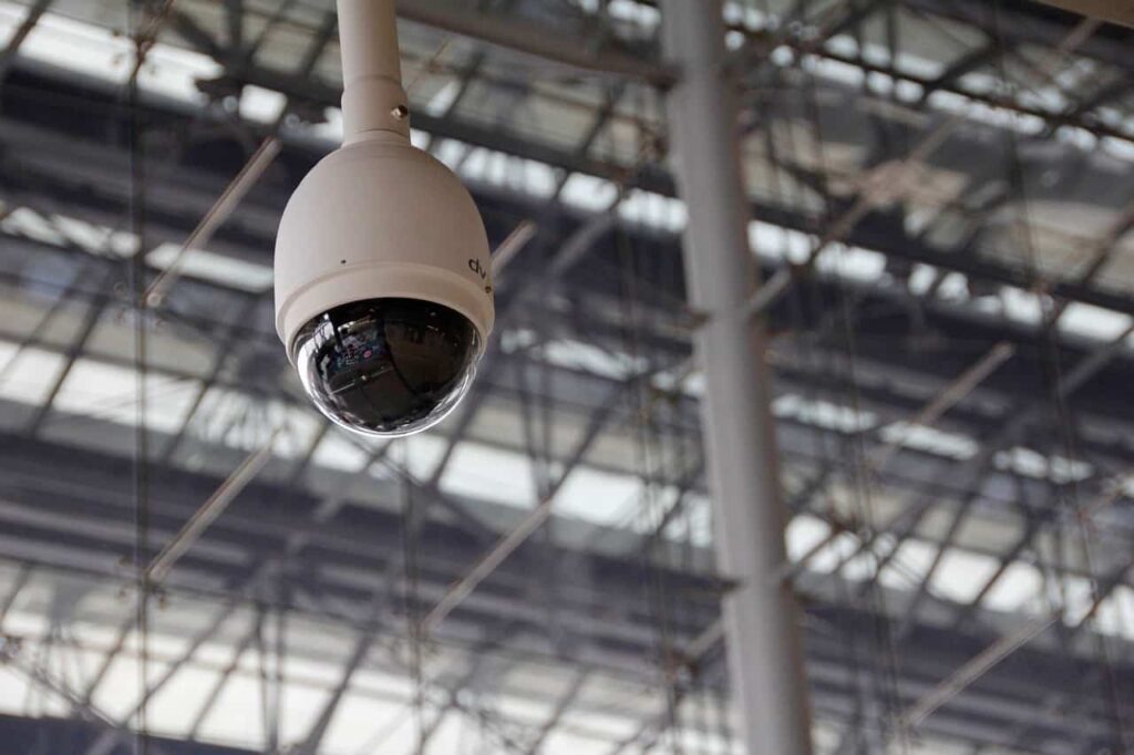 Security camera hung above retail store