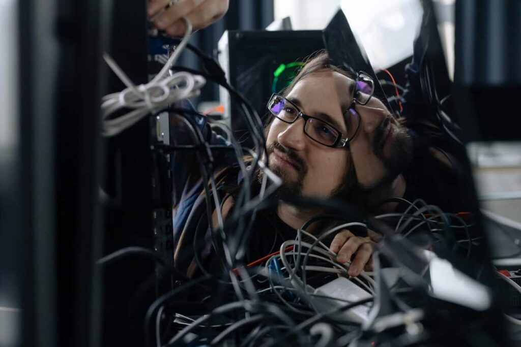 Person working on cables in data center