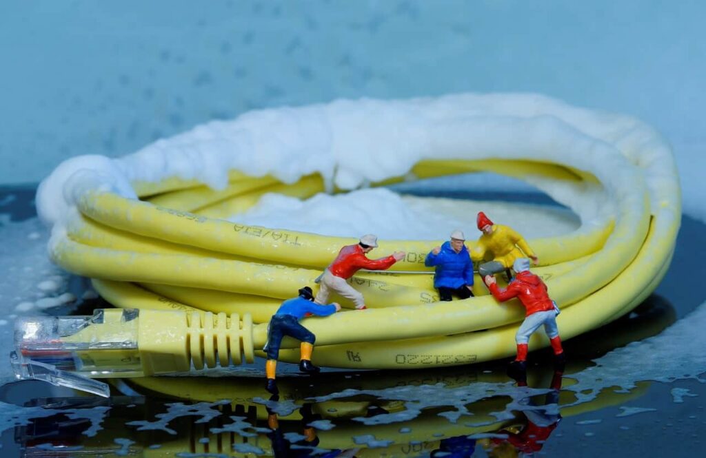 Miniature figures next to an ethernet cord