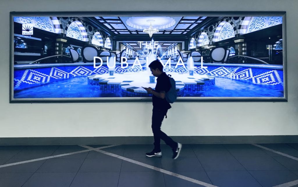 Man walking in front of a large and expensive screen