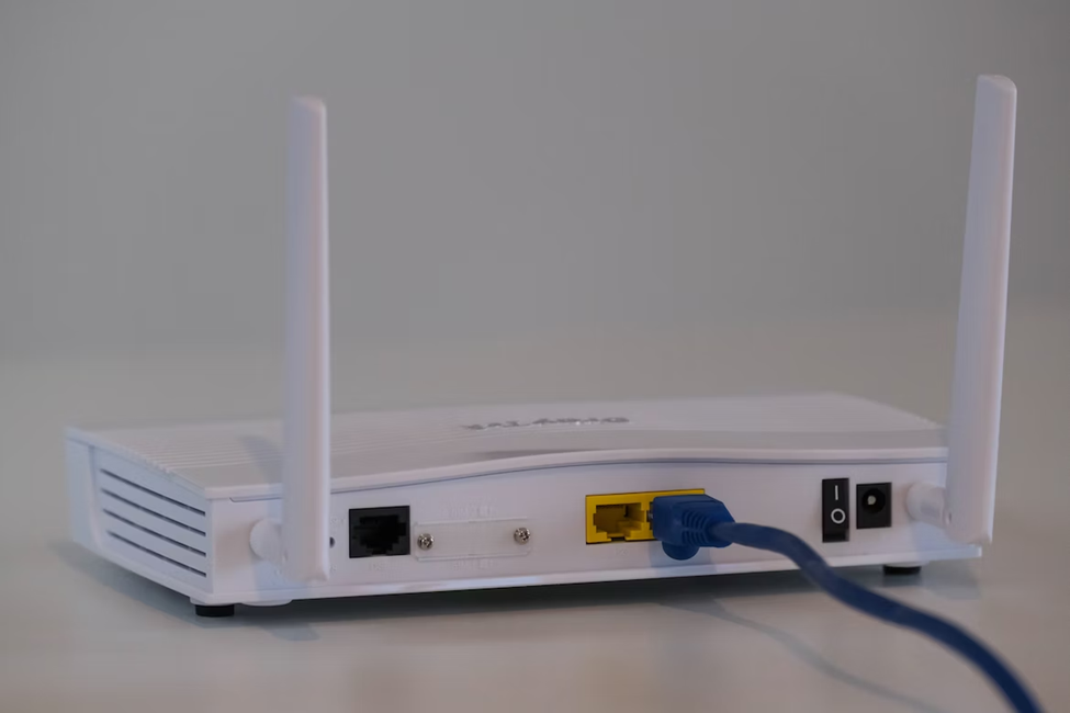 A basic router with an ethernet cable plugged in
